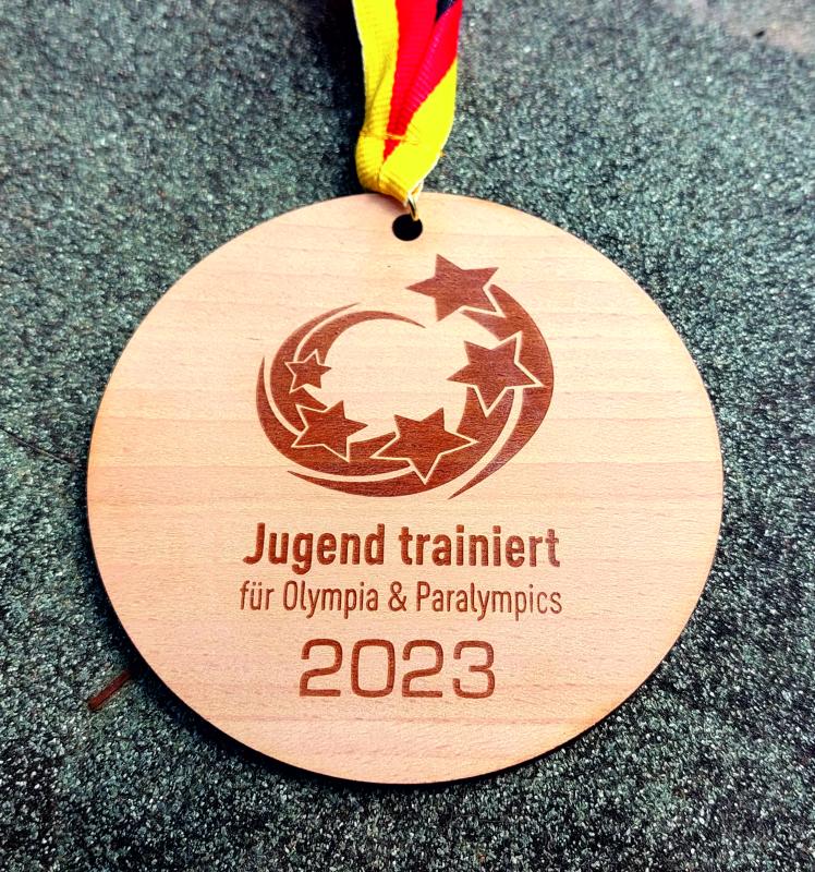 Medaille Olympia Holz